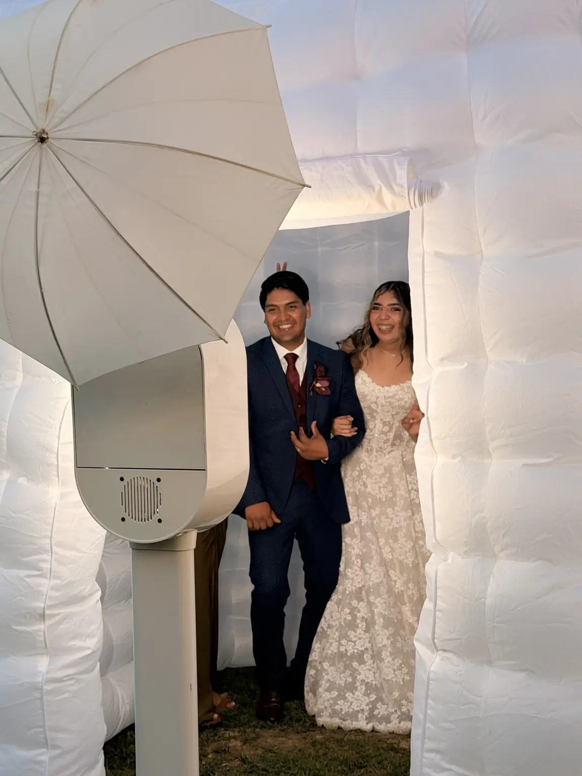 Newlyweds posing beside the Fiesta Booth