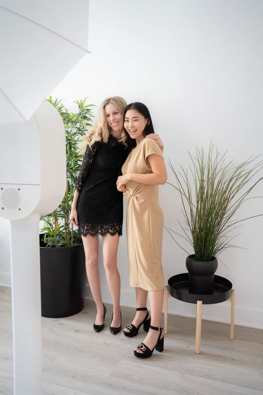 Friends posing together in front of a modern event backdrop